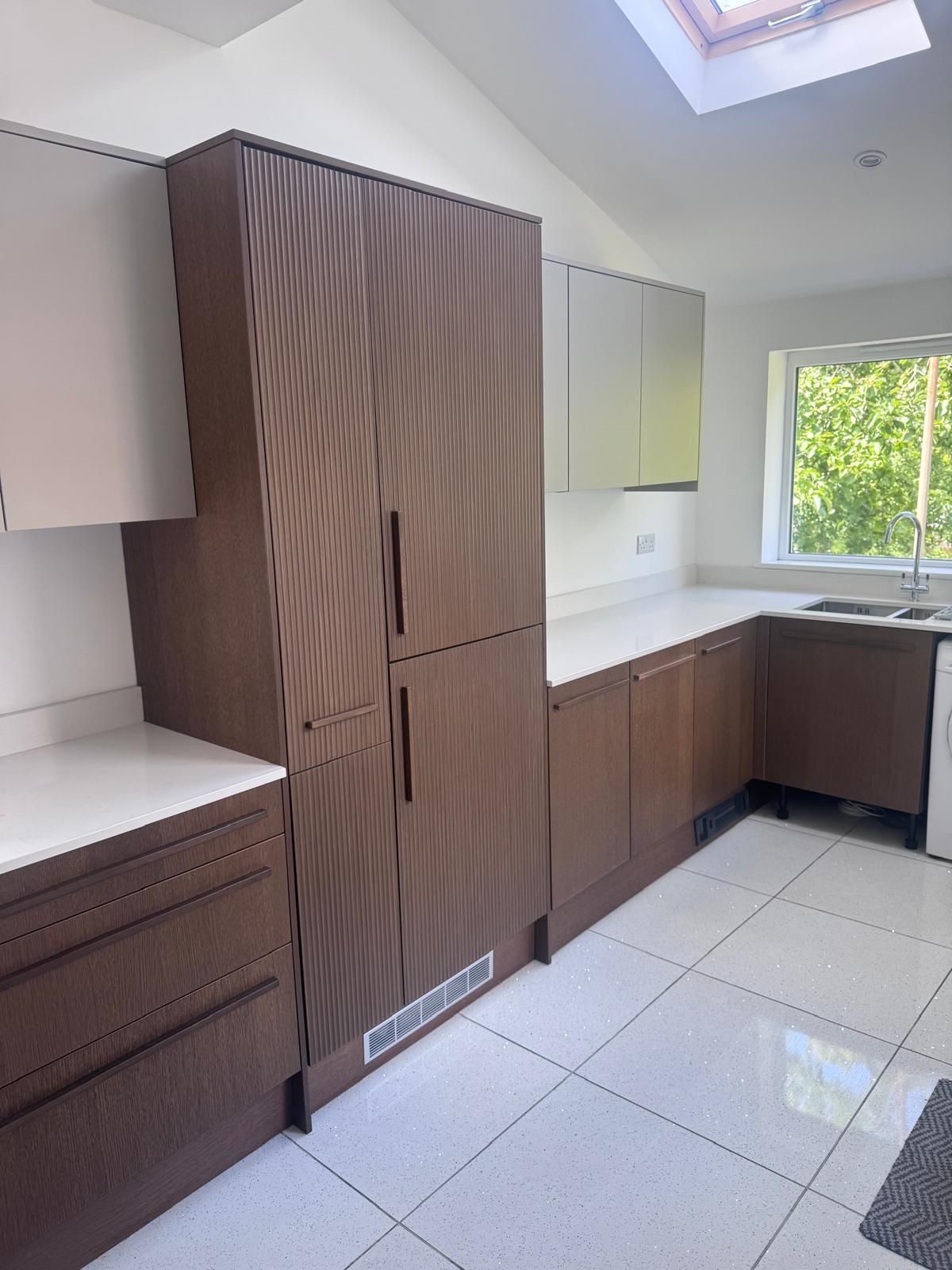 Deep-cleaned kitchen with dark wood cabinetry and gleaming floors